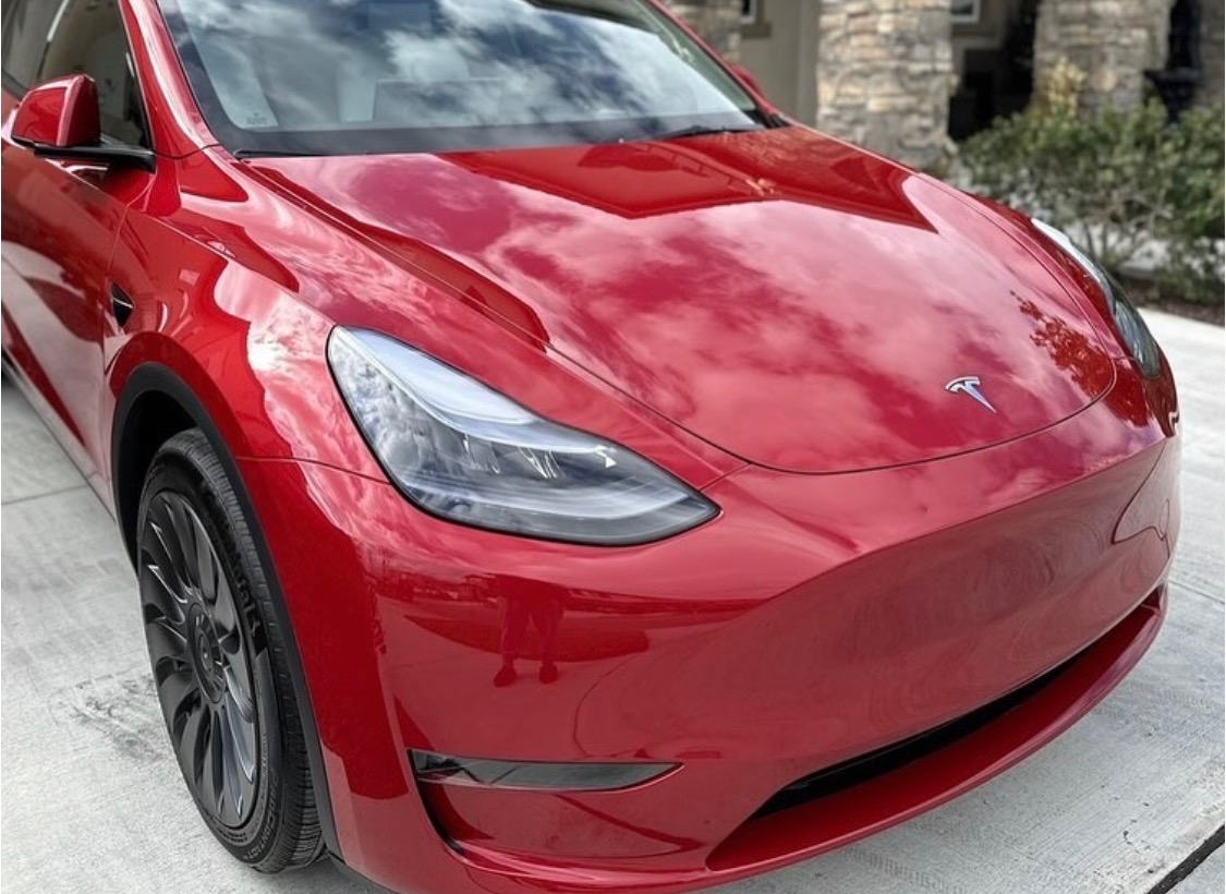 Pristine red Tesla finish after paint repair